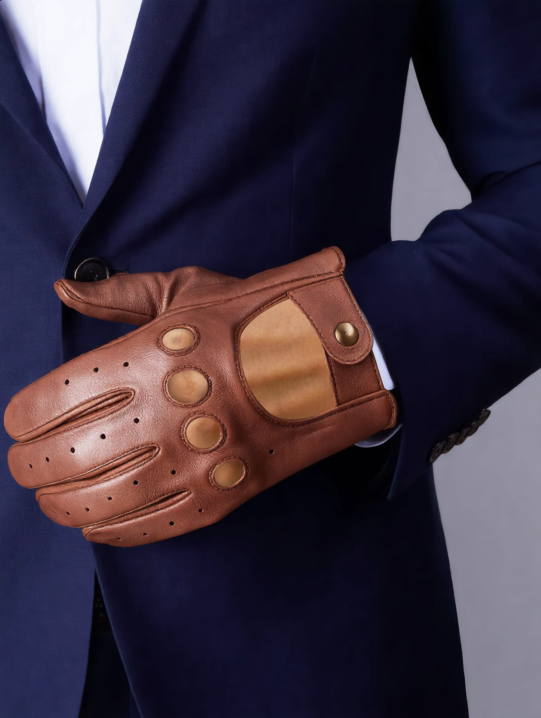 Brown Leather Driving Gloves hand2 Unisex premium leather driving gloves featuring knuckle cutouts, ventilation holes, and a snap-button wrist closure, worn against a neutral background.